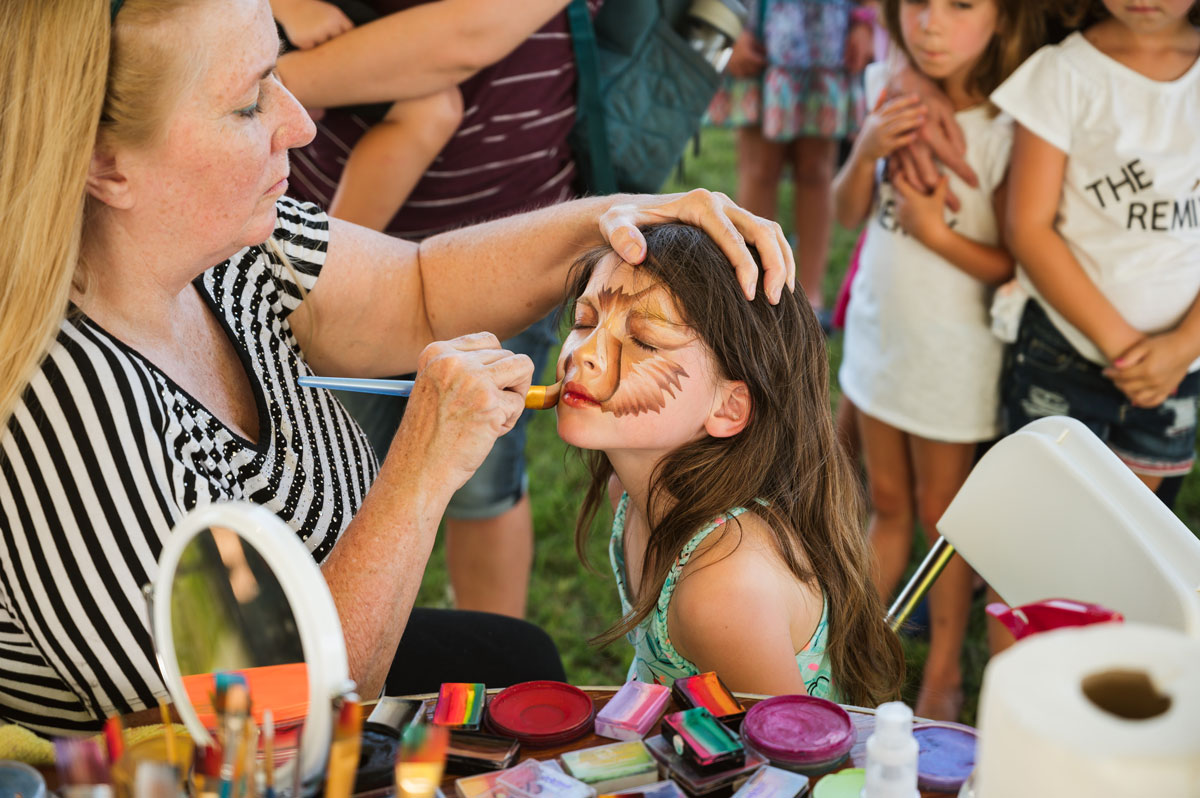 Children getting their faces painted at the event.